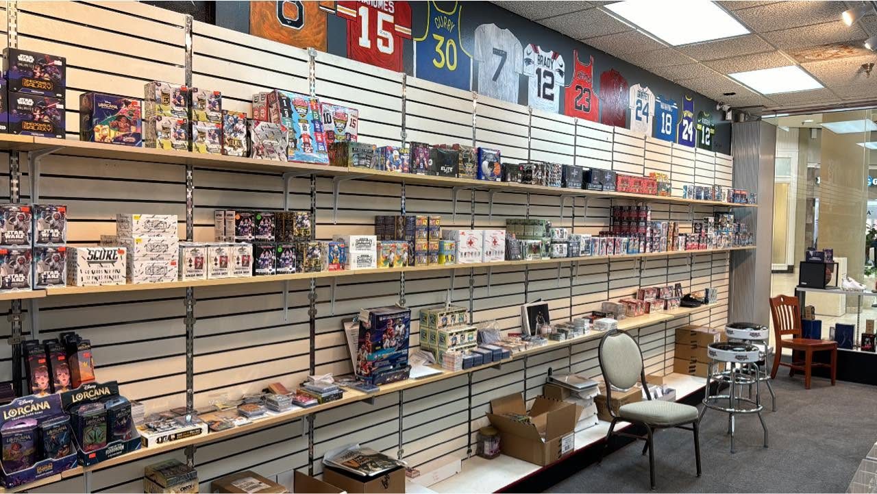 Wall of sealed trading card and hobby boxes at Collectibles and More